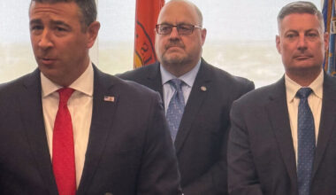 FBI Special Agent in Charge Michael Ratta, left, along with  Long Beach Deputy Inspector Stefan Chernaski and Long Beach Police Commissioner Richard DePalma announced the recovery of more than 20 guns and a "large amount" of cocaine, fentanyl, ecstasy, heroin and more than $100,000 in cash.