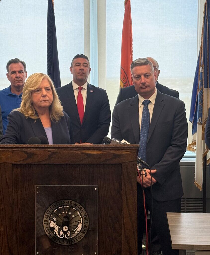 Nassau County D.A. Anne Donnelly, at podium, with Long Beach City Councilman Mike Reinhart, left; FBI Special Agent in Charge Mike Ratta; and acting Police Commissioner Richard DePalma.