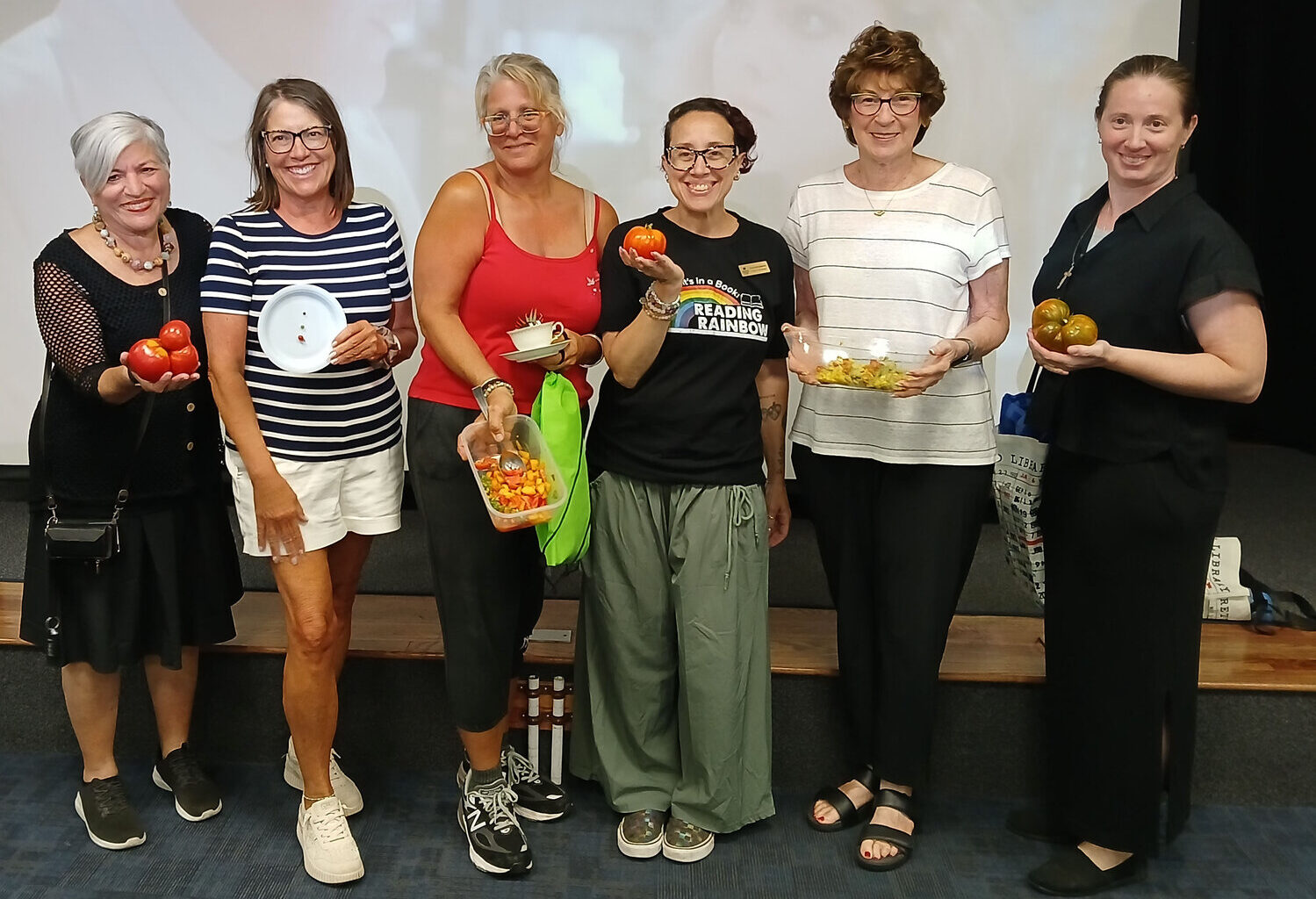 Sheryl Beck, of Lido Beach, far left, won ugliest tomato, while Elizabeth Pryke, of Long Beach, grew the smallest one. Kristen Donovan, of Island Park, earned honorable mention for her peach-tomato salsa; librarian and garden club organizer Nicole Menzzasalma presented prizes. Long Beach resident Beverly Hansel-Silberstang won the tastiest category with a tomato, corn and avocado recipe, and Oceanside resident Marsha Volgyi grew the biggest tomato.