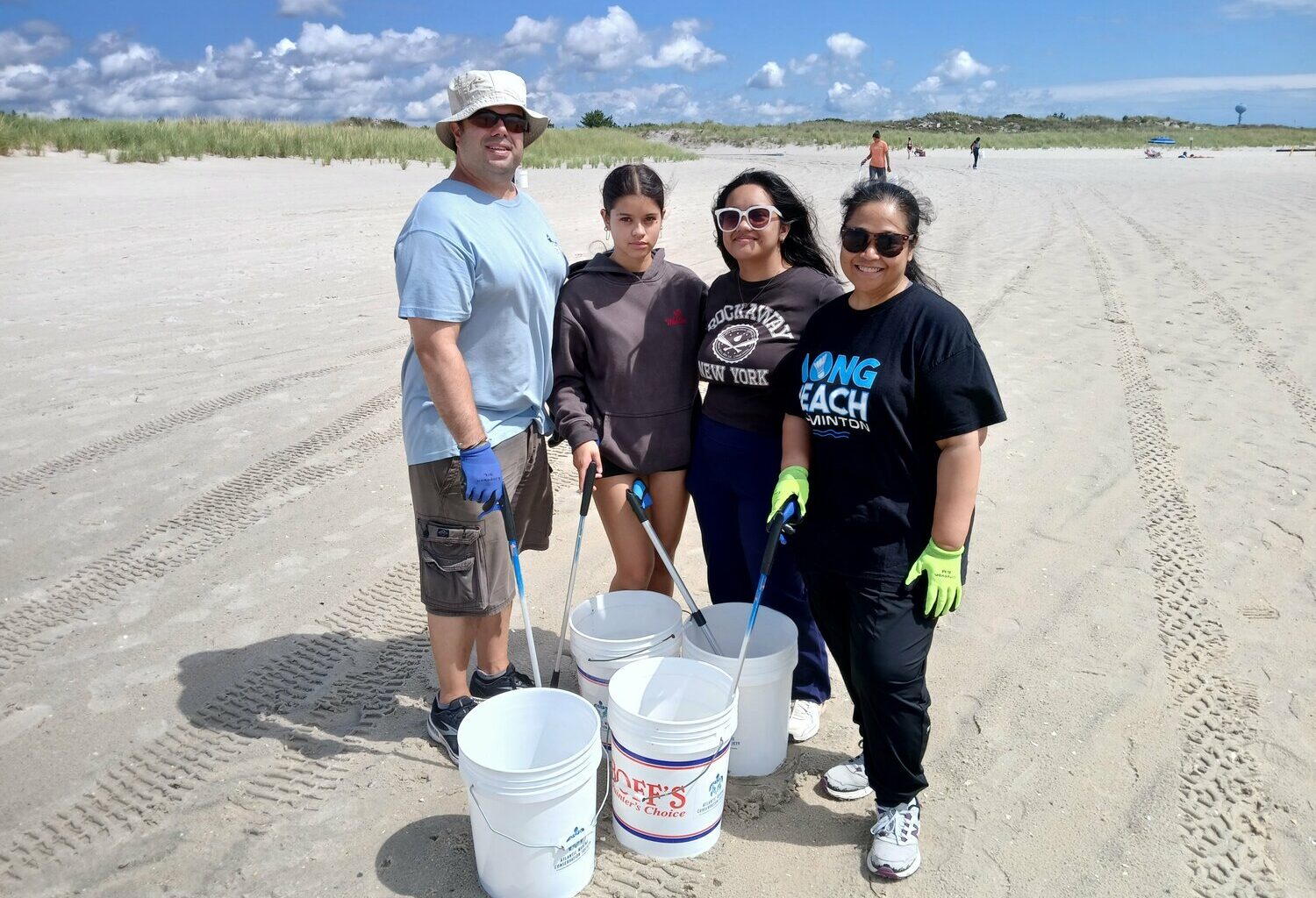 The Siskos, Long Beach locals, turned the cleanup into a family event. Robert, left, Laina, Liahna and Krystal spent the day filling their buckets.