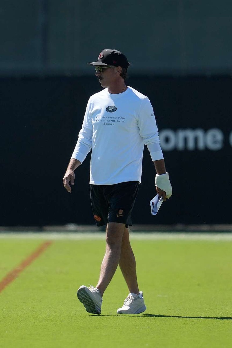San Francisco 49ers head coach Kyle Shanahan walks on the field during the NFL football team's training camp Friday, July 31, 2026, in Santa Clara, Calif. (AP Photo/Jeff Chiu)