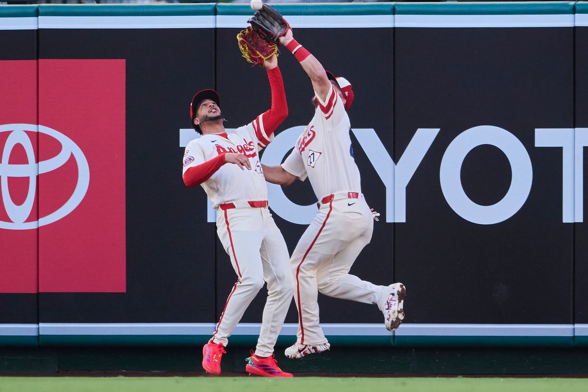 The Los Angeles Angels Mike Trout #27 and Jose Siri #28 collide for an outfield catch during an MLB game against The Milwaukee Brewers on July 31st, 2026 at Angel Stadium in Anaheim, California.