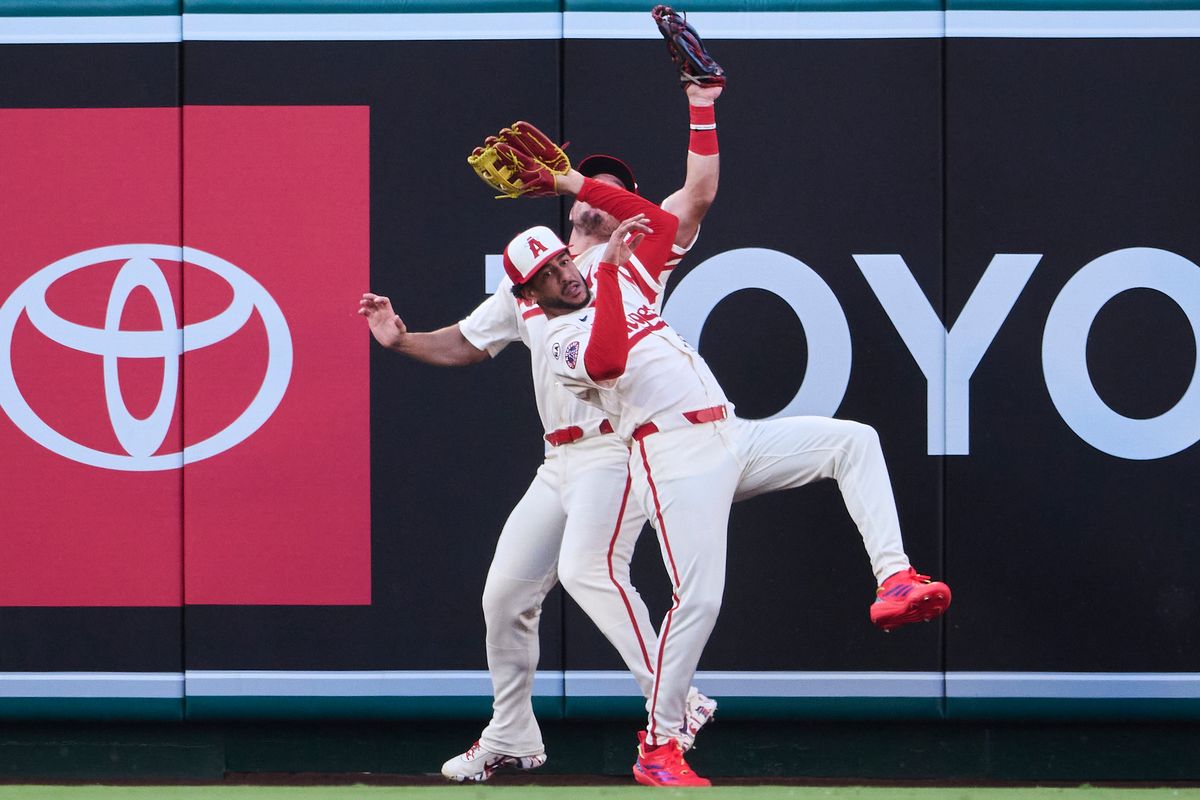 The Los Angeles Angels Mike Trout #27 and Jose Siri #28 collide for an outfield catch during an MLB game against The Milwaukee Brewers on July 31st, 2026 at Angel Stadium in Anaheim, California.