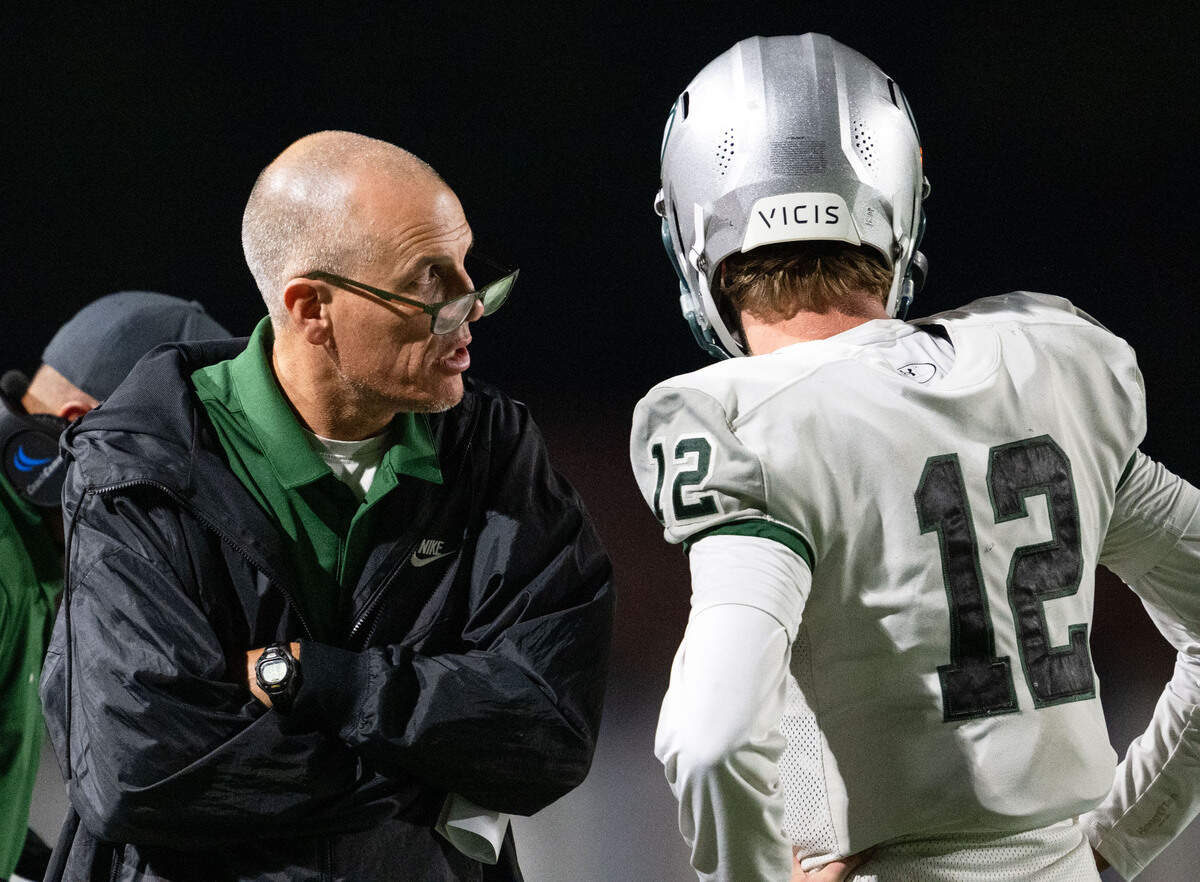 Granite Bay coach Joe Cattolico consults with Grizzlies quarterback Nick Harris during a game in 2024.