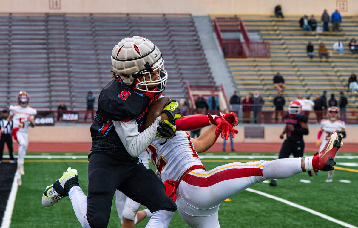 Mira Loma Matadors wide receiver Keion Kado (5) makes a touchdown catch against Foresthill Wildfires cornerback David Silveria (12) as time expires in the first half of the CIF Sac-Joaquin Section Division VIII championship at Hughes Stadium in Sacramento on Saturday, Nov. 29.
