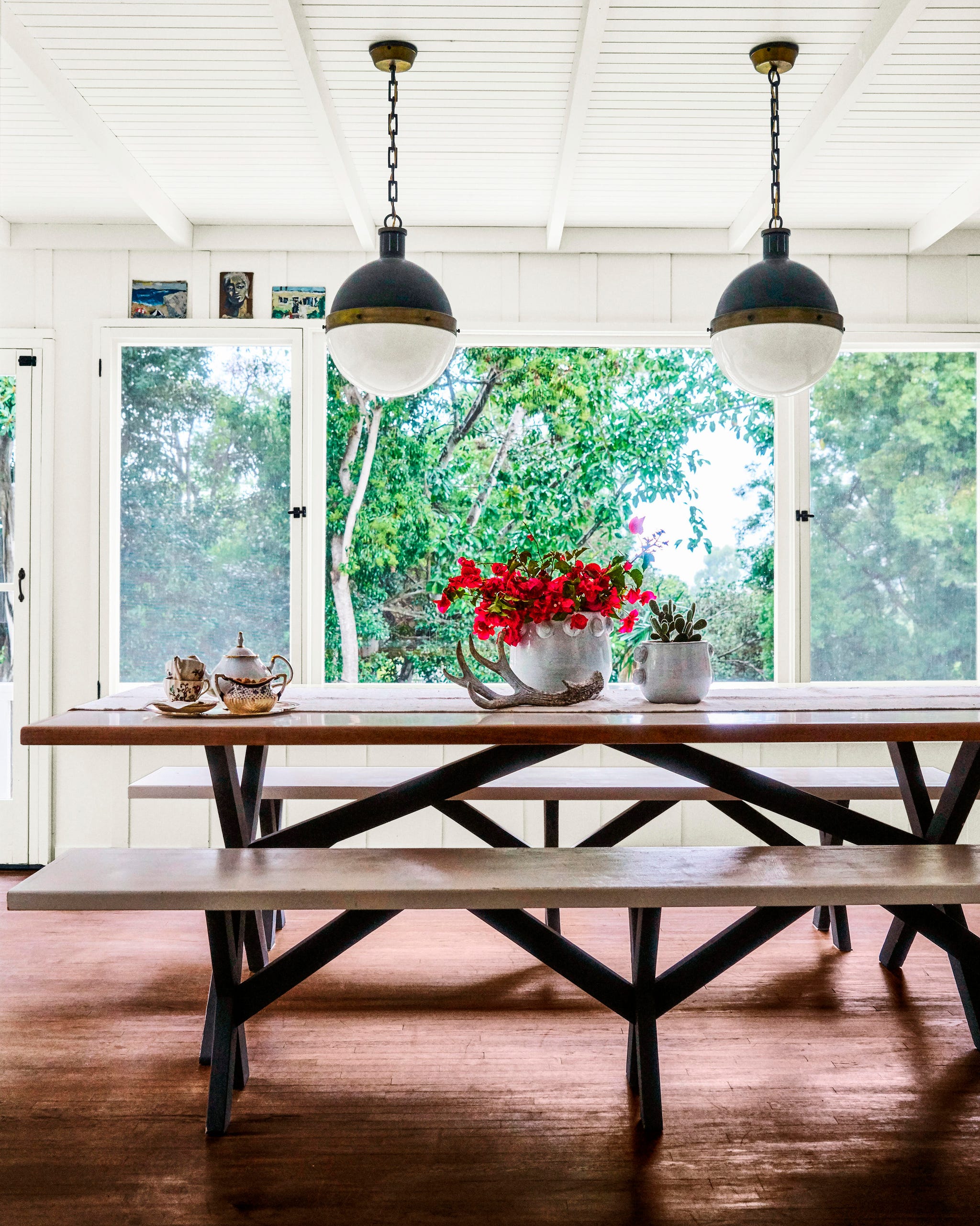 dining room with two pendant lights and a picnic table with benches dining room with two pendant lights and a picnic table with benches