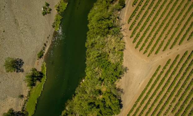 The Russian River flows just south of the Geyserville bridge at Highway 128 in an ever growing dry riverbed, the state water board is scheduled to vote on revised framework for curtailments on Russian River diversions likely to be imposed later this year as well as on a voluntary water sharing. May 12, 2022. (Chad Surmick / The Press Democrat)