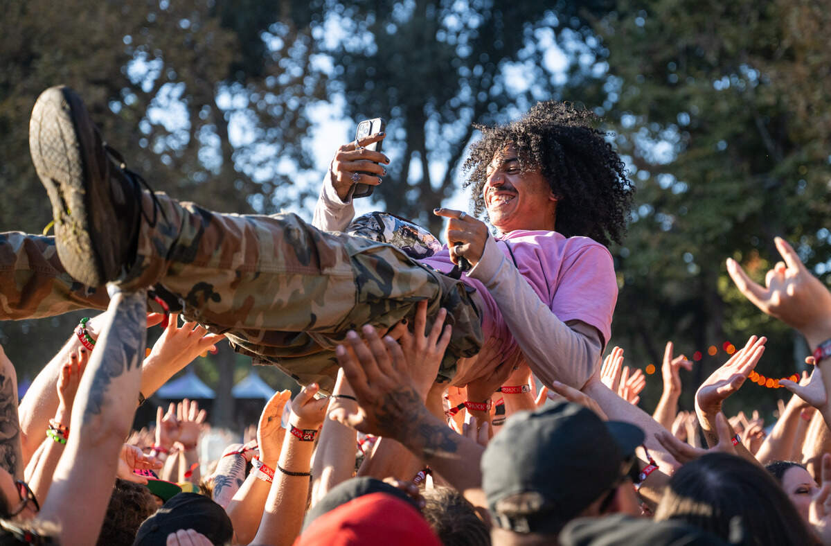 A crowd surfer smiles during the Aftershock festival on Friday, Oct. 3, 2025, in Discovery Park in Sacramento.