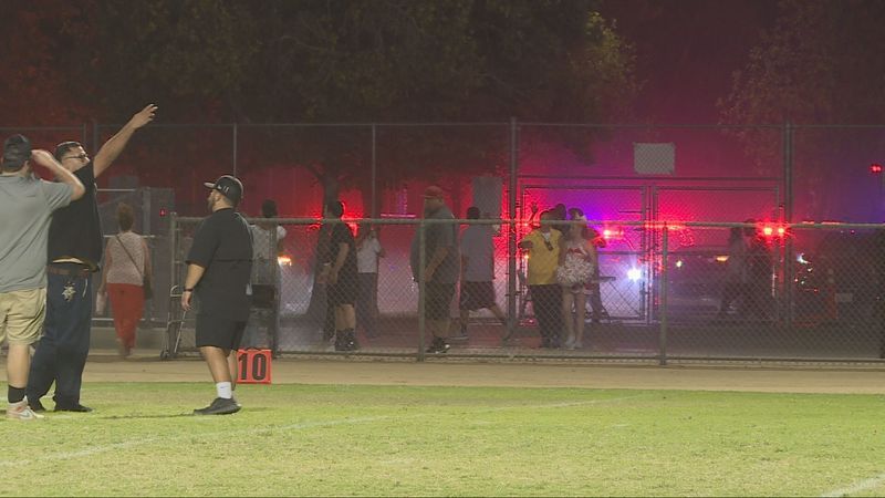 Fans flee after gunshots rang out during Independence High School's football game on Friday, August 21, in Bakersfield, CA. PHOTO: KBAK/KBFX