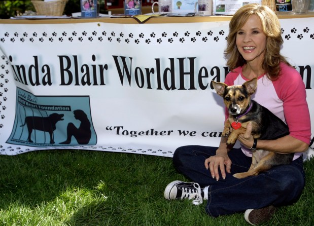Actress Linda Blair poses with her dog, Rudy, during an event promoting "Dine With Your Dog Day" at the Hyatt Regency Century Plaza, in Los Angeles, Thursday, Oct. 19, 2006. (AP Photo/Damian Dovarganes)