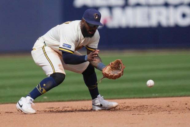Milwaukee Brewers third baseman Luis Rengifo fields a grounder hit by the Dodgers' Alex Freeland before throwing to first base for the out during the fifth inning of a spring training baseball game Monday, March 9, 2026, in Phoenix. (AP Photo/Ross D. Franklin)