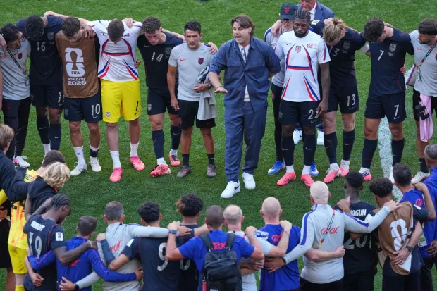 U.S. head coach Mauricio Pochettino speaks to his players after their World Cup loss to Belgium.