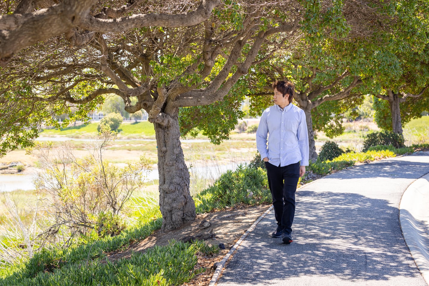 Felix Wong walked on a path near his company, Integrated Biosciences, in Redwood City, Calif.
