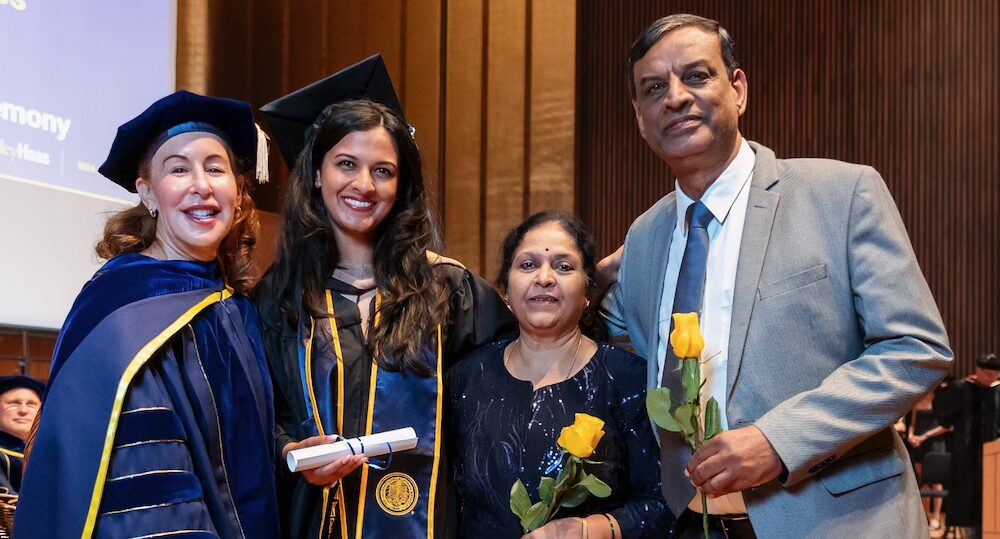 Four people in regalia at Haas commencement
