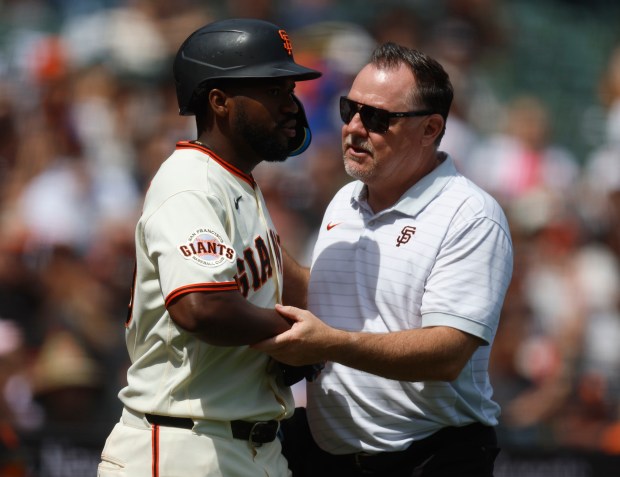 San Francisco Giants' Basabe Osleivis (39) is checked out after being hit by a pitch against the Colorado Rockies in the fifth inning at Oracle Park in San Francisco, Calif., on Sunday, Aug. 16, 2026. He remained in the game. (Nhat V. Meyer/Bay Area News Group)