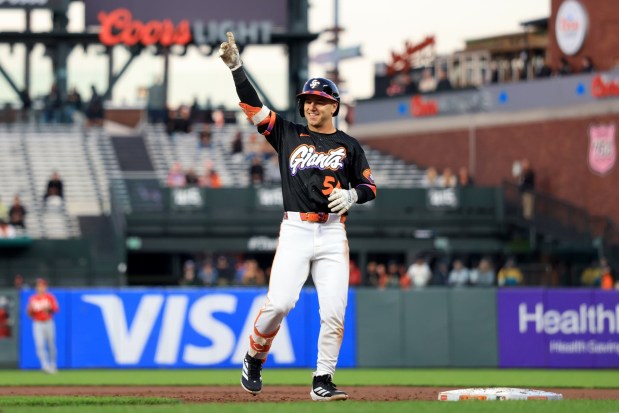 San Francisco Giants' Nate Furman (56) celebrates his first major league hit during the third inning of a MLB game as Cincinnati Reds' Sal Stewart (27) looks on at Oracle Park in San Francisco, Tuesday, Aug. 25, 2026. (Ray Chavez/Bay Area News Group)