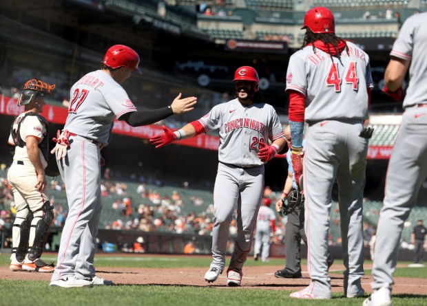 Cincinnati Reds' Eugenio Suárez #28 is congratulated by teammate Sal Stewart #27 after hitting a grand slam home run off San Francisco Giants relief pitcher Dylan Smith #66 in the ninth inning of their MLB game at Oracle Park in San Francisco, Calif., on Wednesday, August 26, 2026. (Jane Tyska/Bay Area News Group)