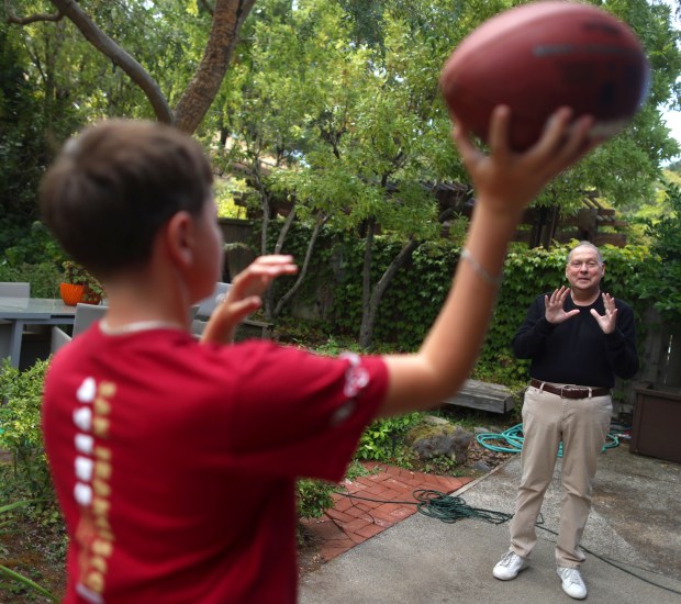 Skyler Shapiro, 11, throws a football with his father Greg Papa on Monday, Aug. 17, 2026, in San Rafael, Calif. Aric Crabb/Bay Area News Group)