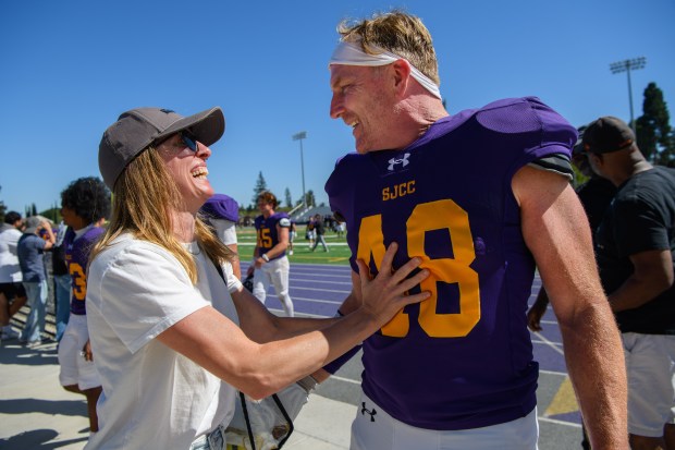 San Jose City College defensive lineman Justin Buzzard (48) is congratulated by his wife Taylor Buzzard after their game against College of the Redwoods at San Jose City College in San Jose, Calif., on Saturday, Aug. 29, 2026. Buzzard, a 47-year-old father of three and pastor, is playing college football to fulfill a long-delayed dream. (Jose Carlos Fajardo/Bay Area News Group)