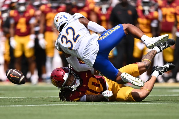 Southern California wide receiver Corey Simms (10) loses the ball after contact with San Jose State cornerback Caleb Womack (32) during the first half of an NCAA college football game, Saturday, Aug. 29, 2026, in Los Angeles. (AP Photo/William Liang)