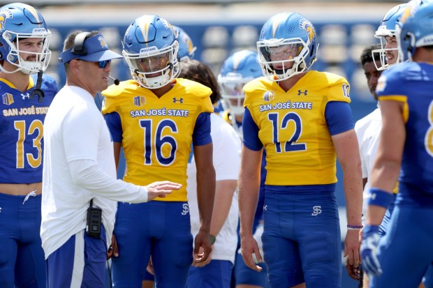 San Jose State Spartans offensive coordinator Craig Stutzmann gives instructions to San Jose State Spartans quarterback CJ Lee (16), San Jose State Spartans quarterback Robert McDaniel (12) and their temmates during the San Jose State Spartans spring football showcase at CEFCU Stadium in San Jose, Calif., Saturday, April 18, 2026. (Ray Chavez/Bay Area News Group)
