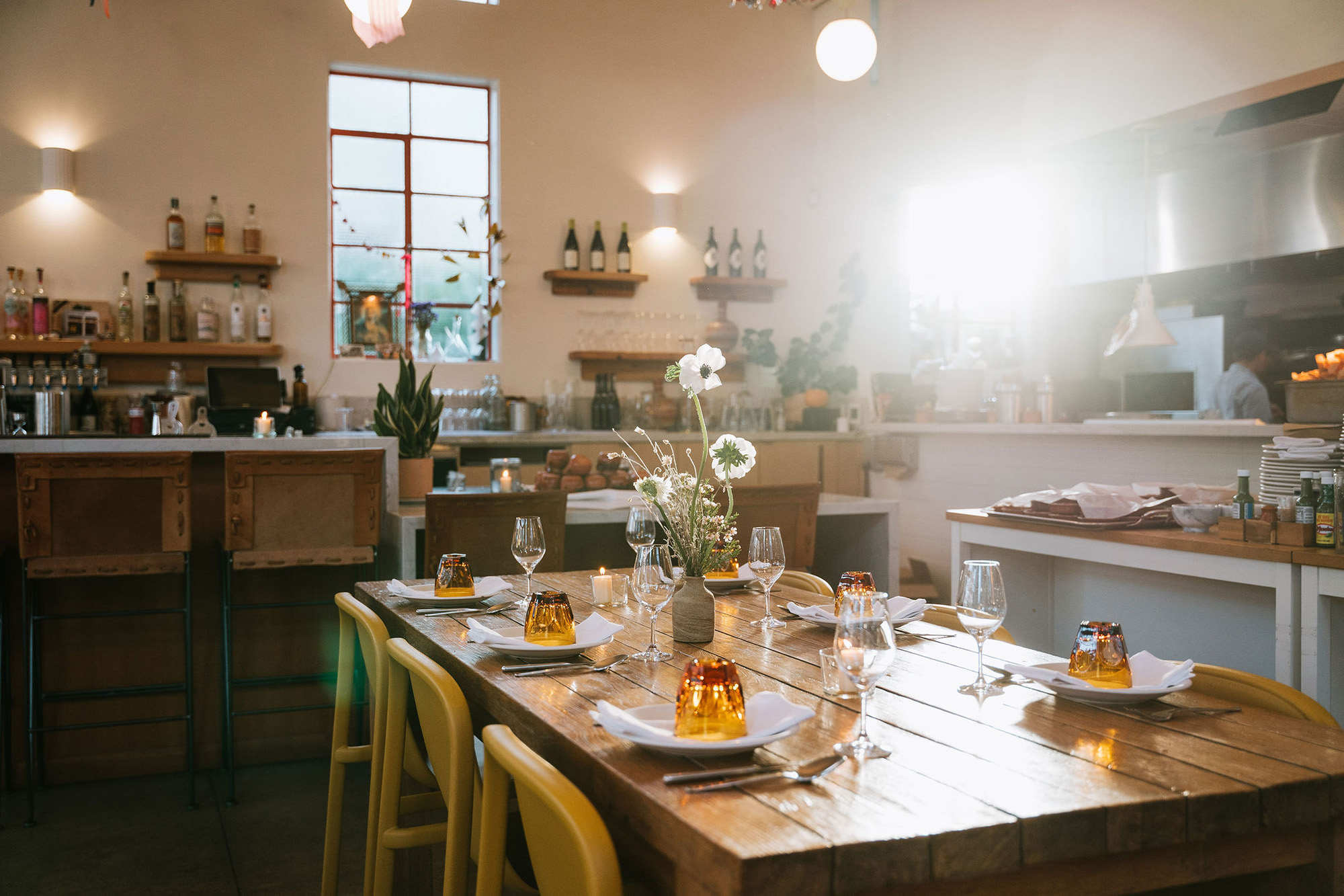 Sun-dappled table inside a sunny restaurant dining room.