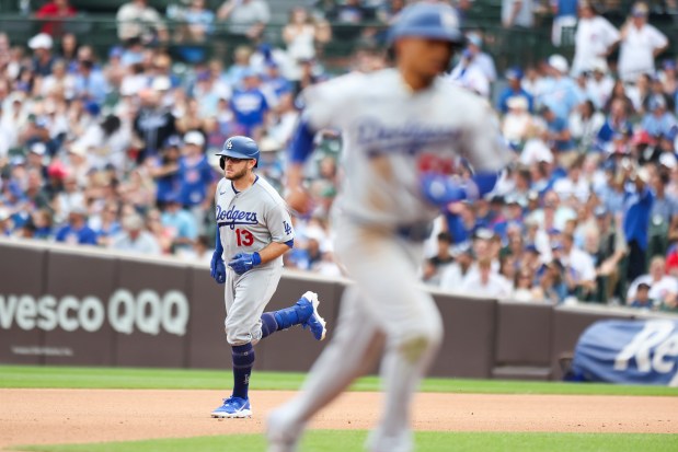Dodgers third baseman Max Muncy, left, rounds the bases after hitting a three-run home run in the eighth inning against the Cubs on Wednesday, Aug. 5, 2026, at Wrigley Field. (Eileen T. Meslar/Chicago Tribune)