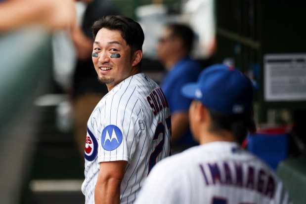 Cubs right fielder Seiya Suzuki, left, speaks with pitcher Shota Imanaga in dugout in the fourth inning against the Dodgers on Wednesday, Aug. 5, 2026, at Wrigley Field. (Eileen T. Meslar/Chicago Tribune)