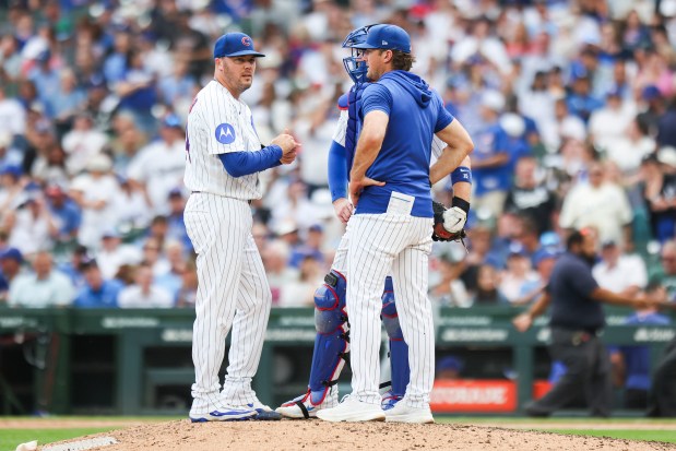 Cubs pitching coach Tommy Hottovy, right, speaks with Caleb Thielbar after the reliever gave up a three-run home run in the eighth inning against the Dodgers on Wednesday, Aug. 5, 2026, at Wrigley Field. (Eileen T. Meslar/Chicago Tribune)