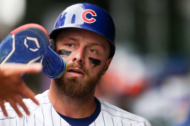 Cubs first baseman Michael Busch high-fives teammates in the dugout after scoring in the seventh inning against the Dodgers on Wednesday, Aug. 5, 2026, at Wrigley Field. (Eileen T. Meslar/Chicago Tribune)