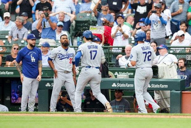 Dodgers designated hitter Shohei Ohtani (17) celebrates with teammates after hitting a two-run home run in the eighth inning against the Cubs on Wednesday, Aug. 5, 2026, at Wrigley Field. (Eileen T. Meslar/Chicago Tribune)
