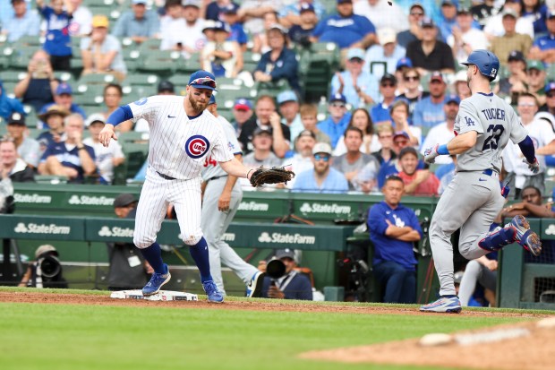 Cubs first baseman Michael Busch catches a throw from third baseman Alex Bregman to retire Dodgers right fielder Kyle Tucker the ninth inning Wednesday, Aug. 5, 2026, at Wrigley Field. (Eileen T. Meslar/Chicago Tribune)