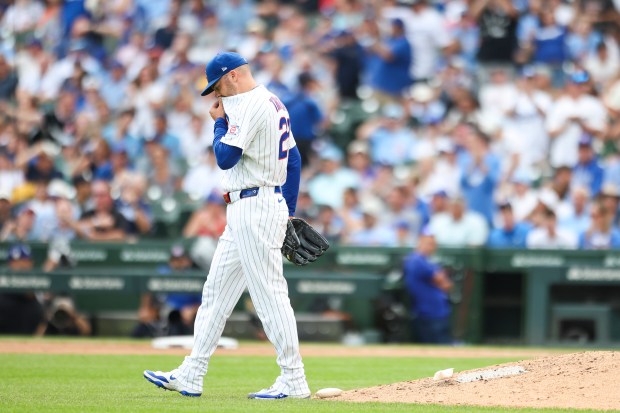 Cubs reliever Caleb Thielbar wipes his face after giving up a three-run home run to the Dodgers' Max Muncy in the eighth inning Wednesday, Aug. 5, 2026, at Wrigley Field. (Eileen T. Meslar/Chicago Tribune)