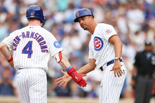 Cubs designated hitter Pete Crow-Armstrong slaps hands with third-base coach Quintin Berry after hitting a two-run home run in the fourth inning against the Dodgers on Wednesday, Aug. 5, 2026, at Wrigley Field. (Eileen T. Meslar/Chicago Tribune)