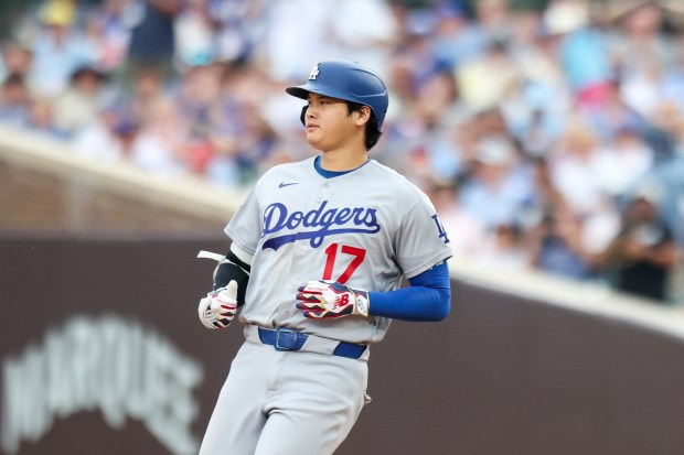 Dodgers designated hitter Shohei Ohtani rounds the bases after hitting a two-run home run in the eighth inning against the Cubs on Wednesday, Aug. 5, 2026, at Wrigley Field. (Eileen T. Meslar/Chicago Tribune)