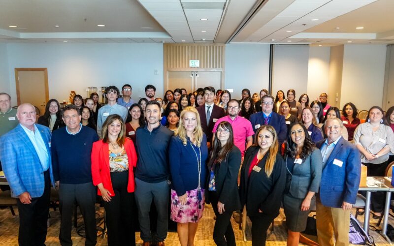 Jessica Stern, dean of the College of Humanities and Social Sciences, and Cherie Rolapp, director of the Passage to the Future program, pose for a group photo with students during Titans Reach Higher Weekend.