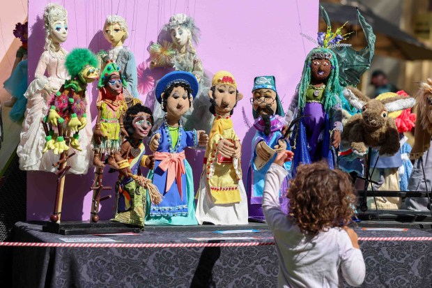 A child takes a closer look at historic puppets on display during the 70th anniversary of the Storybook Puppet Theater at Children's Fairyland in Oakland, Calif., on Saturday, Aug. 29, 2026. The weekend Puppet Fair featured performances on multiple stages by the San Francisco Bay Area Puppeteers Guild and other artists, a display of historic puppets and hands-on workshops where children made rod puppets. "It's like Coachella for people who love puppets, puppet shows and puppeteers," organizers said. (Ray Chavez/Bay Area News Group)
