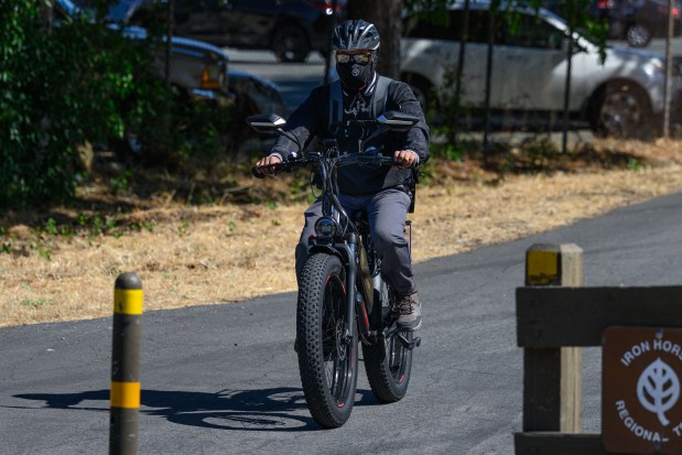 An e-bike rider rides along the Iron Horse Trail in Pleasant Hill, Calif., on Thursday, July 2, 2026. (Jose Carlos Fajardo/Bay Area News Group)