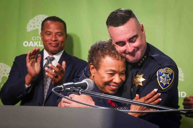 New Oakland Police Chief James Beere and Mayor Barbara Lee embrace as she congratulates him during his official announcement at Oakland City Hall in Oakland, Calif., on Thursday, July 9, 2026. (Ray Chavez/Bay Area News Group)