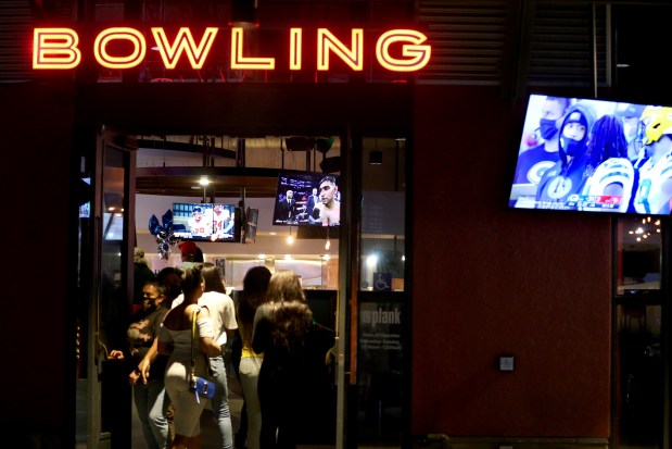 Customers walk in and out of the Plank bowling venue in Jack London Square in Oakland in 2020. (Ray Chavez/Bay Area News Group)
