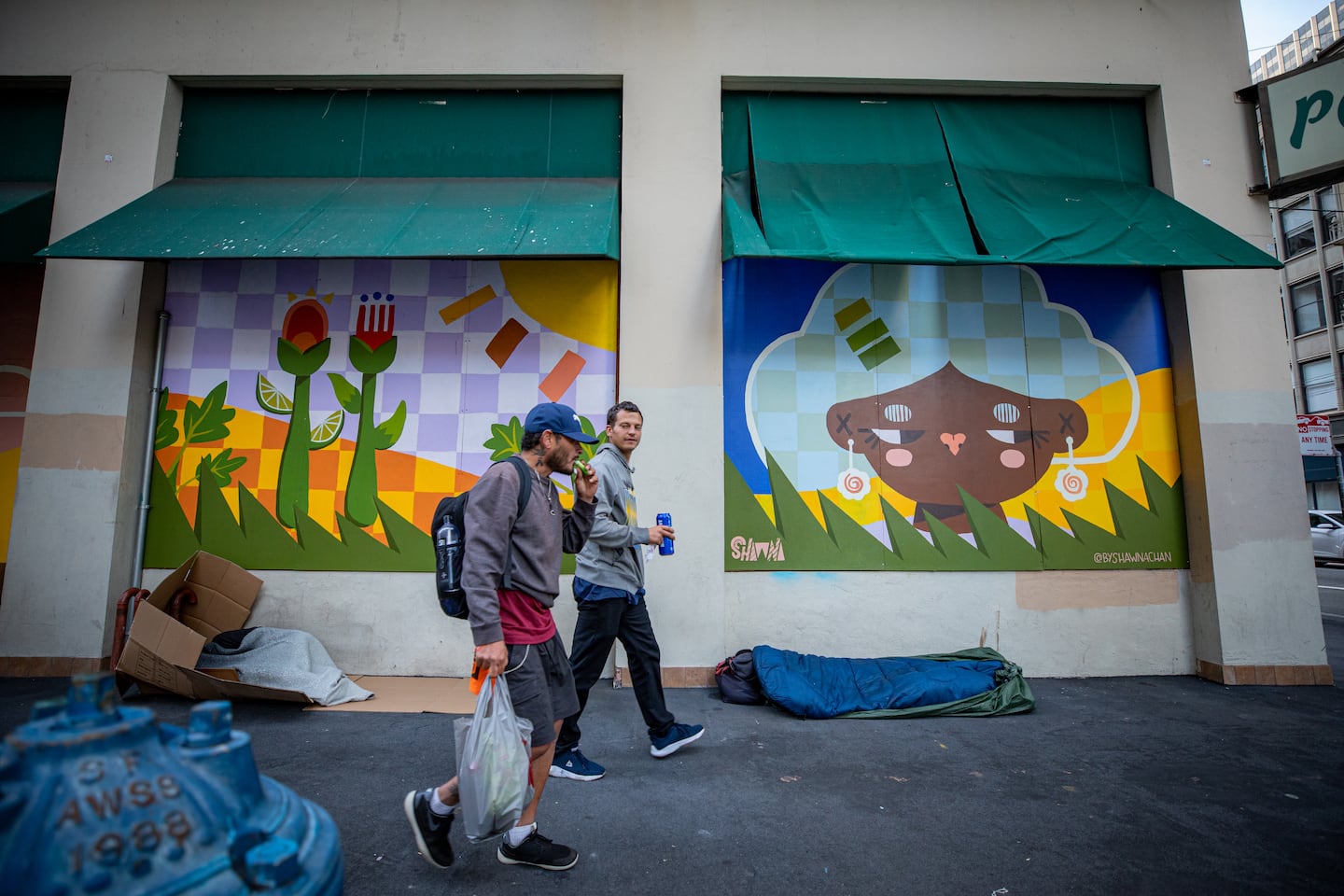 Pedestrians passed people sleeping in cardboard structures and sleeping bags across the street from the Salesforce Tower in downtown San Francisco in 2023.