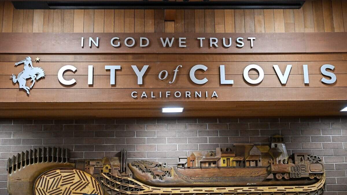 A mural and sign stand above the dais in the Clovis city council chambers in Clovis on Monday, Aug. 11, 2026.