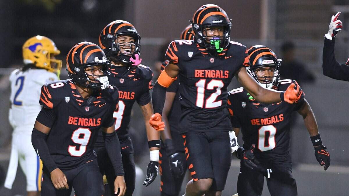 Central East celebrates Trey Greenwood's interception, #12, intended for Grant's Deangelo "DLo" Knight, far left background, in week 2 action Friday night, Aug. 28, 2026 in Fresno.