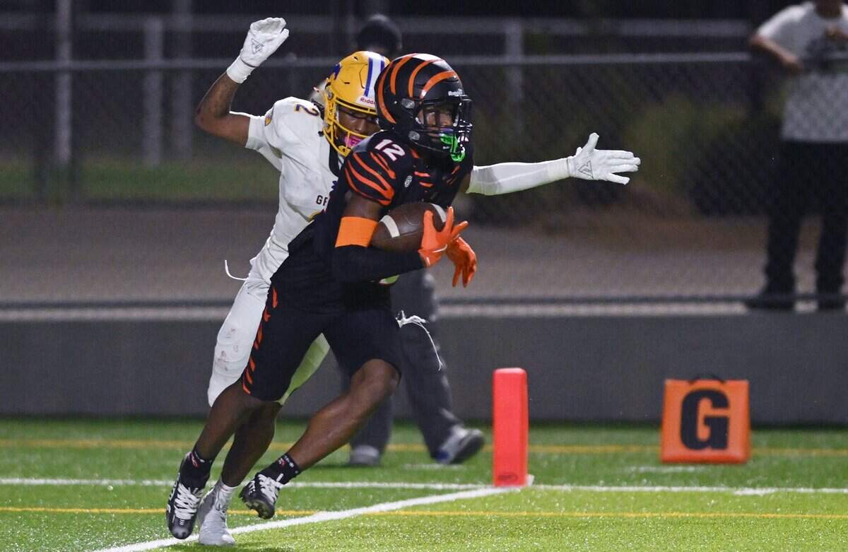 Central East's Trey Greenwood, foreground, intercepts a pass at the goal line intended for Grant's Deangelo "DLo" Knight, background, in week 2 action Friday night, Aug. 28, 2026 in Fresno.