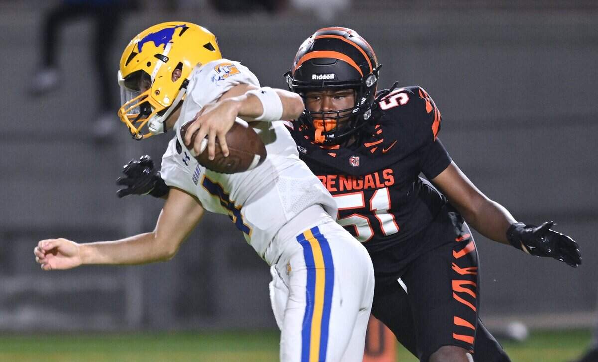 Grant's quarterback Blake Nycum, left, is pressured by Central East's Kahlil Williams for a sack in week 2 action Friday night, Aug. 28, 2026 in Fresno.