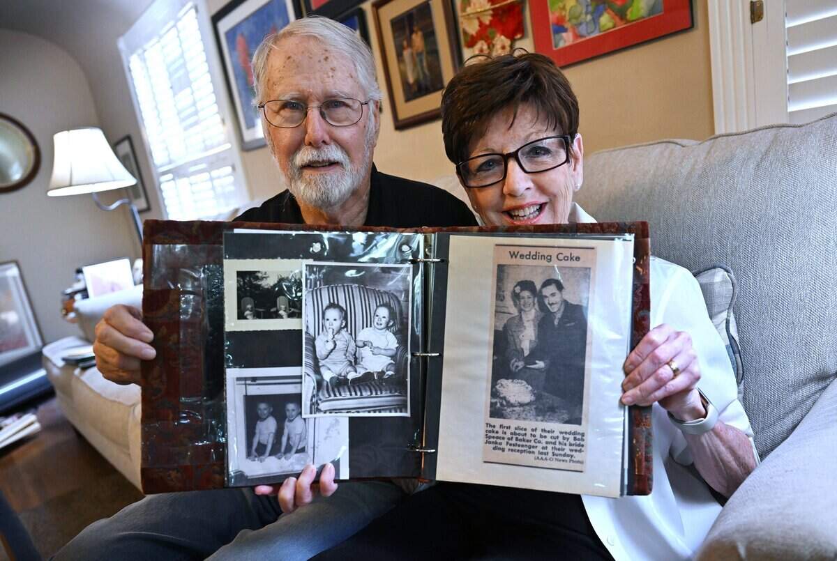 Oscar Speace, left, with his wife Janice Noga, holds an album including photographs of his mother Janke Festinger, during an interview Friday, Aug. 7, 2026 in Fresno. Janke, a Romanian Jew, lived through concentration camps in WWII and wrote a 60-page letter about her life which her son Oscar turned into a one-woman theatrical production. His wife Janice, who has portrayed Janka in the past, will present as Janka again for two final shows at Second Space in Fresno.