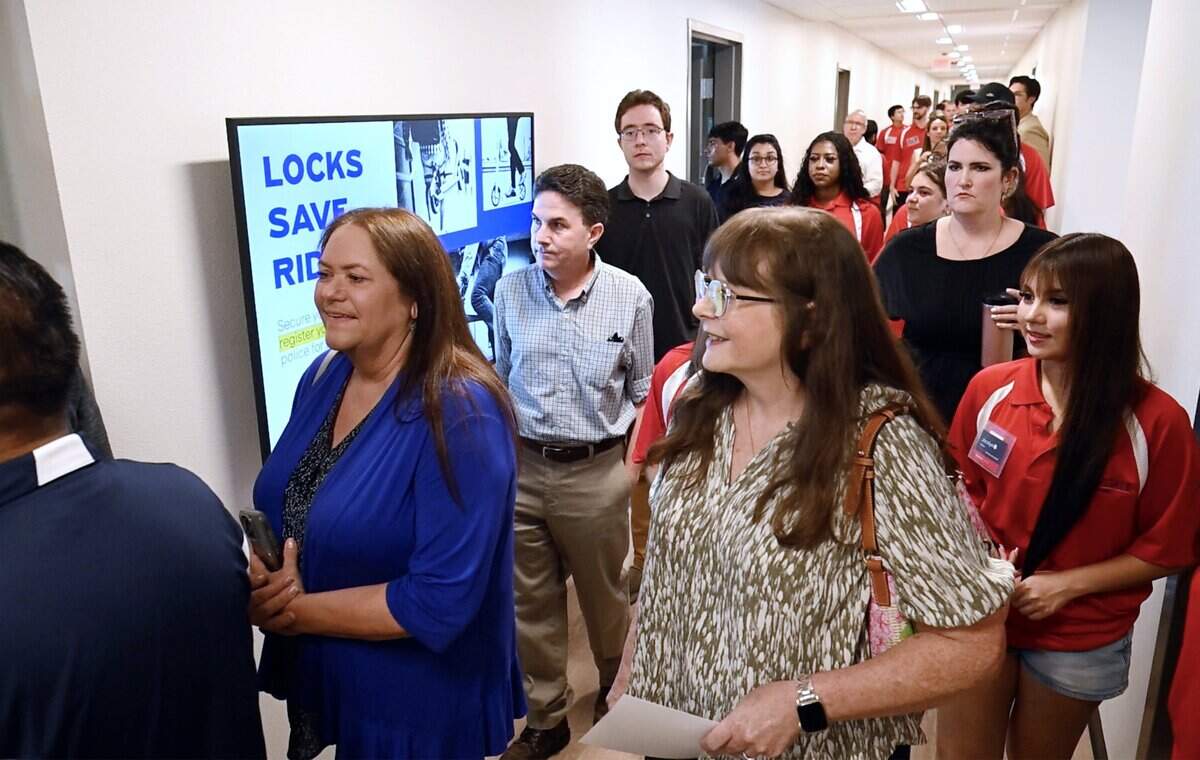 Guests walk the first floor hallway on a tour of Fresno State's new student housing Tuesday morning, Aug. 11, 2026 in Fresno.