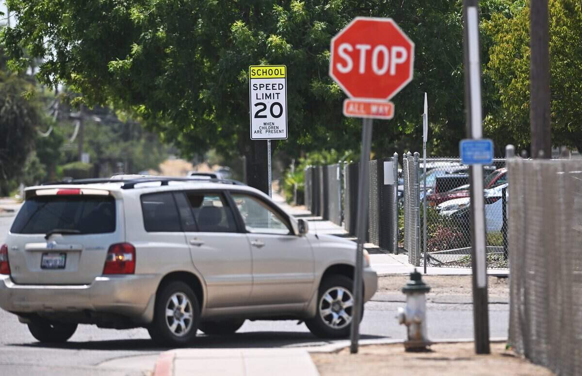 A new speed limit sign, down from 25 mph to 20 mph, is seen outside Career Technical Education Charter High School (CTEC) at the corner of Floradora Avenue and Angus Street on Wednesday, Aug. 12, 2026 in Fresno.