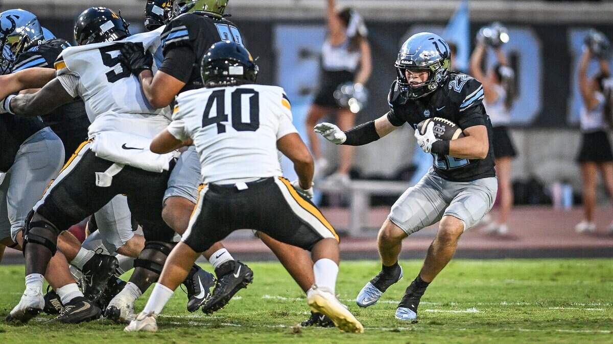 Clovis North's JR Cruz, right, looks for an opening on a run during the Bronco's game against Edison at Veterans Memorial Stadium in Clovis on Thursday, Aug. 27, 2026.
