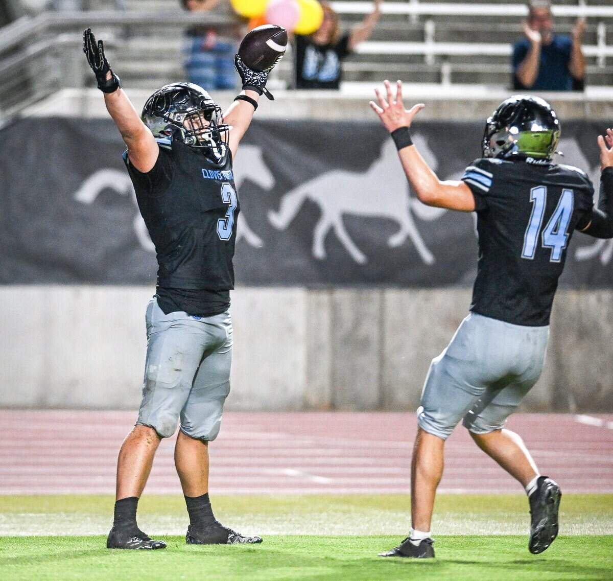 Clovis North’s Cooper Haydock, left, celebrates his touchdown with teammate Archer Chochrek after blocking an Edison punt attempt at Veterans Memorial Stadium in Clovis on Thursday, Aug. 27, 2026.